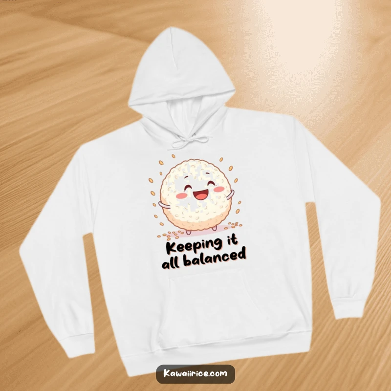 Funny rice ball hoodie showcasing a grinning character skillfully juggling tiny grains, perfect for cozy relaxation.